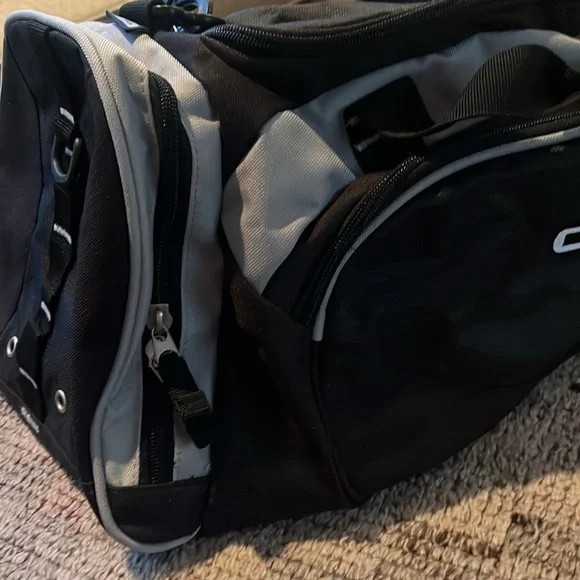 New OGIO sports illustrated black and gray duffle bag with shoulder strap.